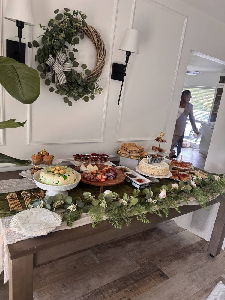 Event table seen from the side, with tiered trays and fresh flowers